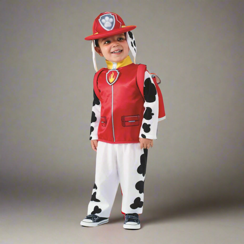 Child wearing a cow-themed costume with a red vest and helmet on a white background