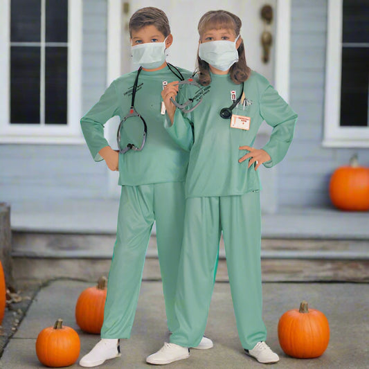 Two children in green medical scrubs with stethoscopes and masks on a white background